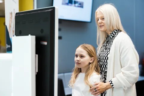 A parent and a child doing a self-care path together on a DentView screen